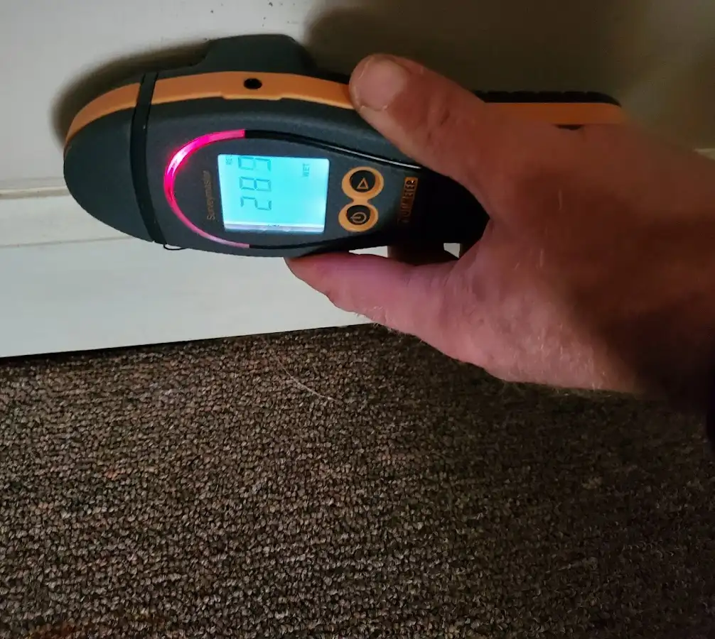Moisture detection at baseboard during Storm Damage Restoration in Oak Grove